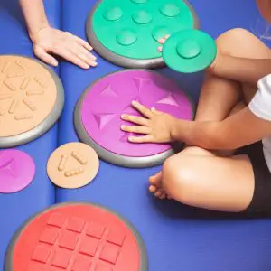 Occupational Therapy in Toronto, child playing with sensory disks 