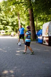 Therapeutic Recreation in Toronto: 
Boy and man playing soccer on the pavement