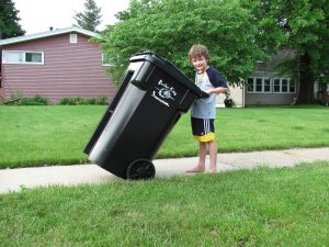 Boy taking out the trash after an Occupational Therapy in Toronto session