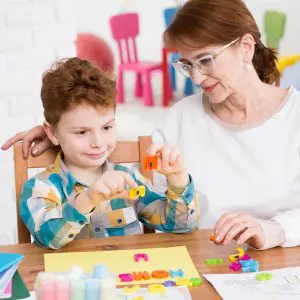Boy working with therapist in an IBI session for autism treatment.