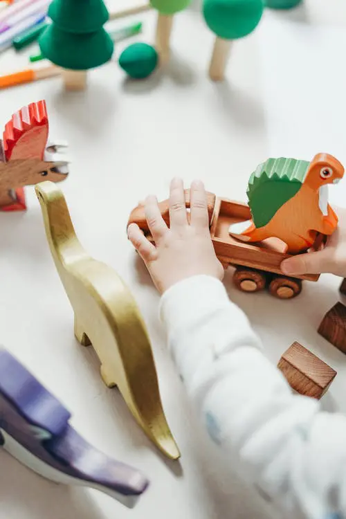 Child playing with wooden toys. What kinds of therapy does a child with autism need? 